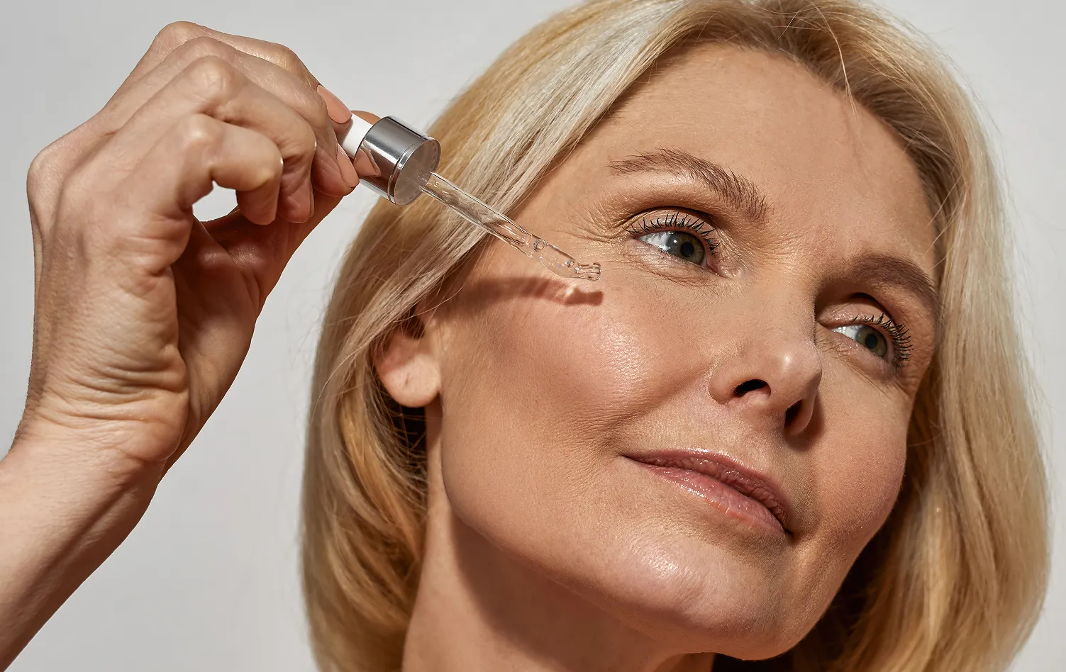Woman applying serum