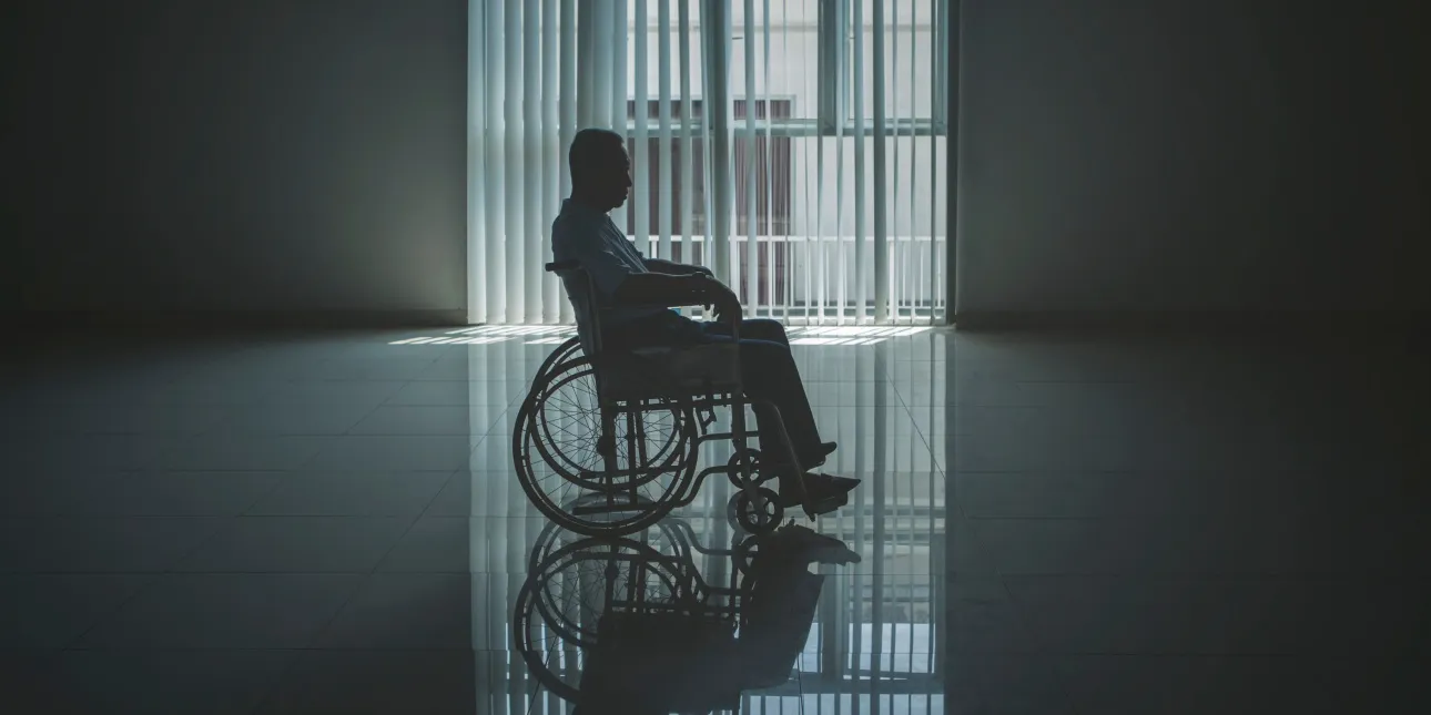 Person sitting alone by a window