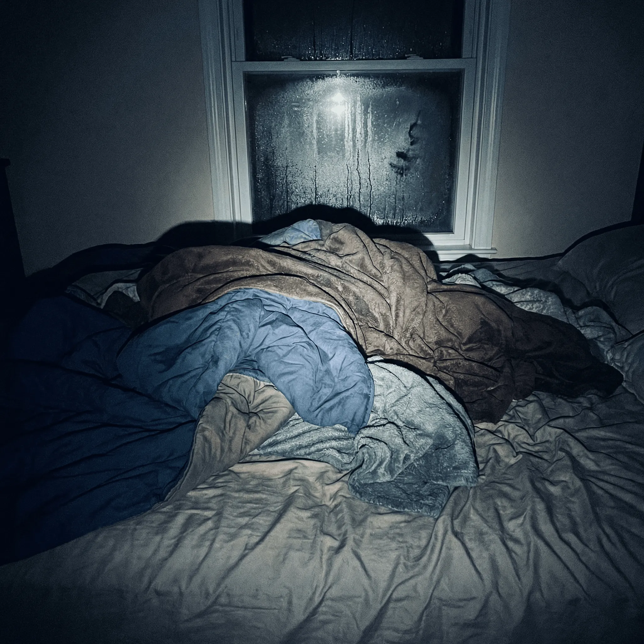 Damp cotton blankets on a bed during a power outage