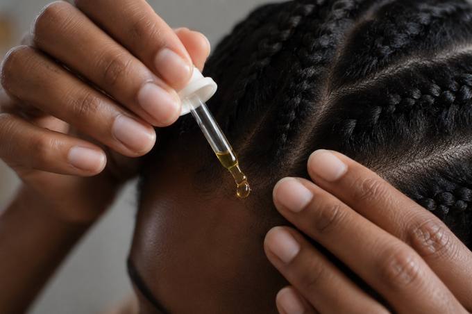 Applying oil along scalp parts