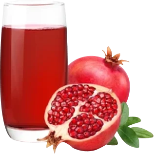 Glass of pomegranate juice beside a whole and halved pomegranate.
